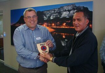 WC DMC director Greg Pillay handing Andy Connell of the NSRI his plaque