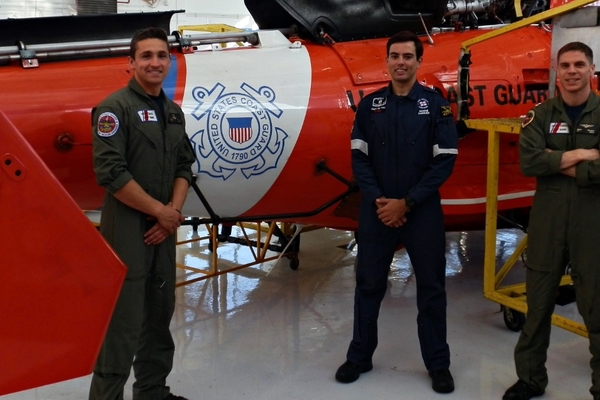 Petty Officer Ernie Child Marc de Vos Lt Mark Sajovic in front of a sea rescue MH 65 Dolhpin chopper